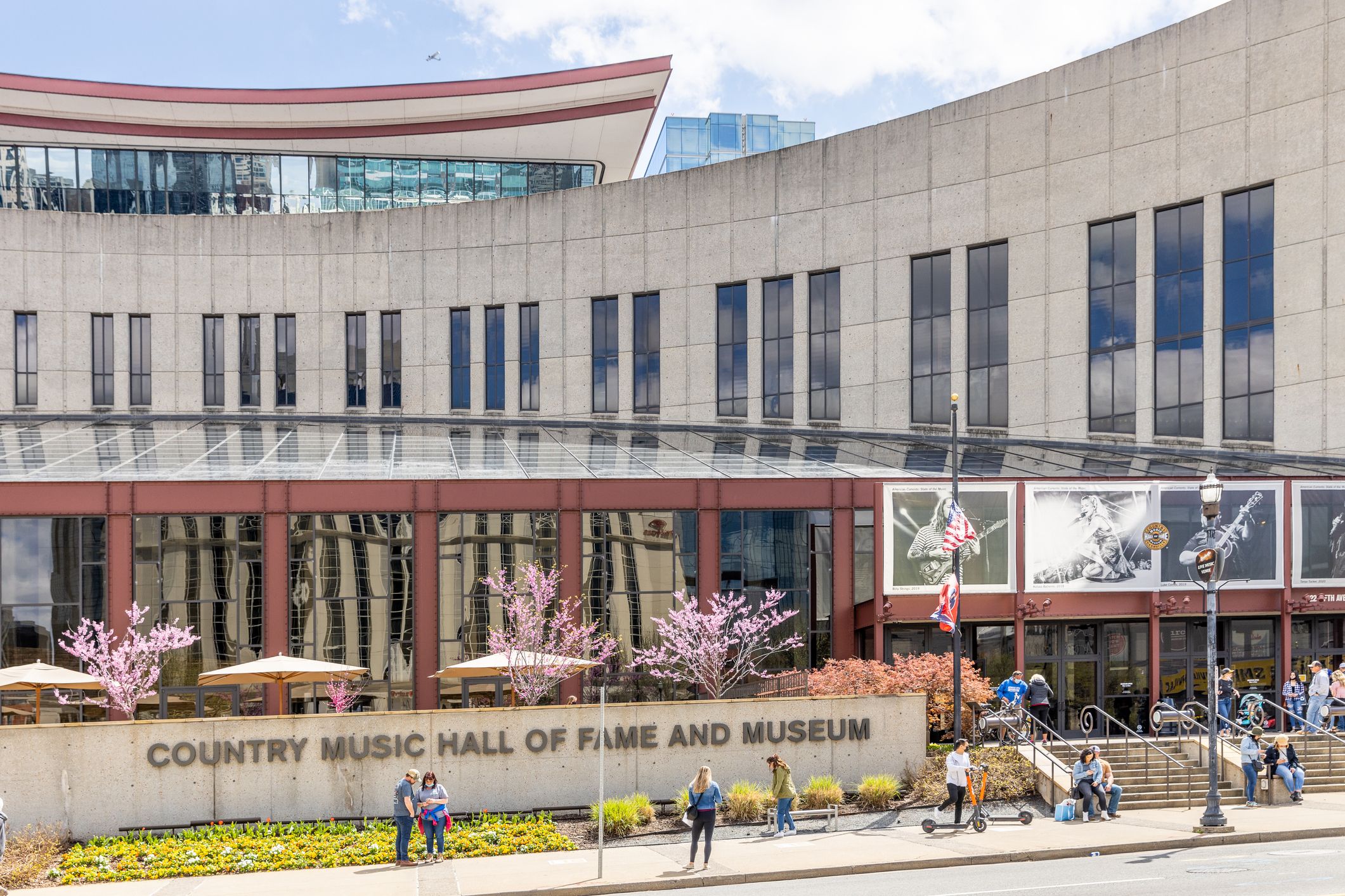 The Country Music Hall of Fame building with people walking around in downtown Nashville, TN.