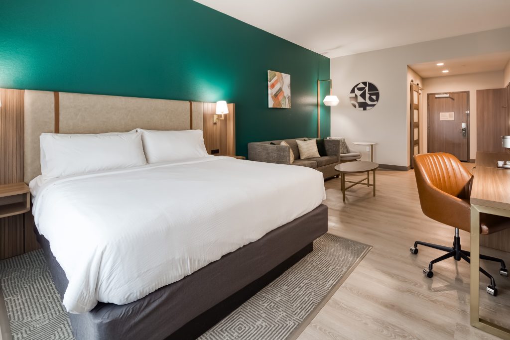 Modern hotel room with King bed, sofa - Holiday Inn Nashville Airport