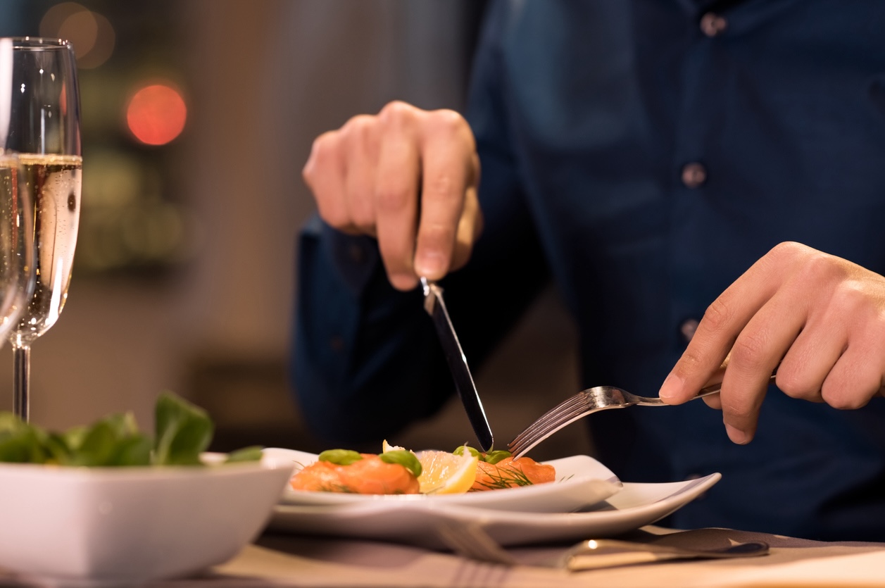Guest enjoying a plated dinner and wine at a restaurant, illustrating onsite dining convenience in Nashville.